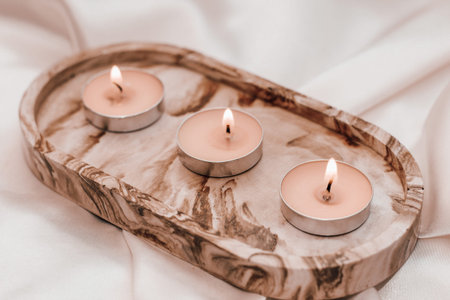 Gypsum marble decorative stand with candles on the background of silk stand.の写真素材