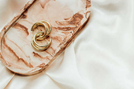 Gypsum marble decorative stand and gold decoration on the background of silk stand.の写真素材