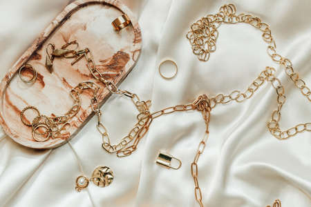 Gypsum marble decorative stand and gold decoration on the background of silk stand.の写真素材