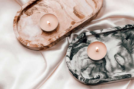 Gypsum marble decorative stand with candles on the background of silk stand.の写真素材