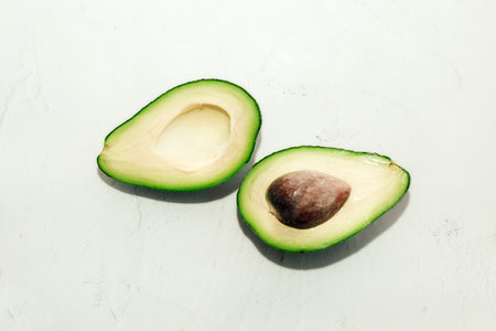 Green ripe avocado on a light background, healthy food concept.の写真素材