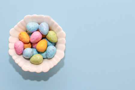 Multi-colored Easter decorative eggs on a pastel background.の写真素材