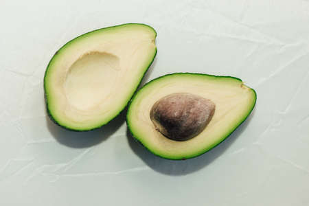 Green ripe avocado on a light background, healthy food concept.の写真素材