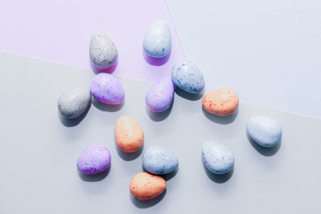 Purple lavender chocolate easter candy eggs on paper background.の写真素材