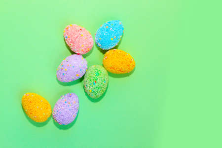 Multi-colored Easter decorative eggs on a pastel background.の写真素材