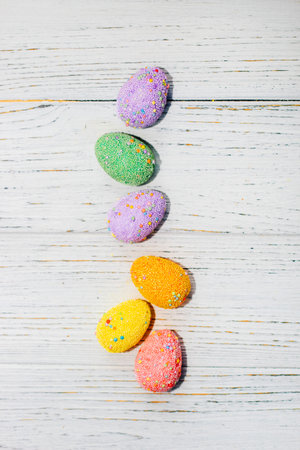 Multi-colored Easter decorative eggs on a pastel background.