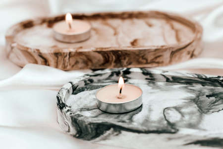 Gypsum marble decorative stand with candles on the background of silk stand.の写真素材