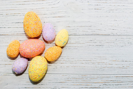Multi-colored Easter decorative eggs on a pastel background.