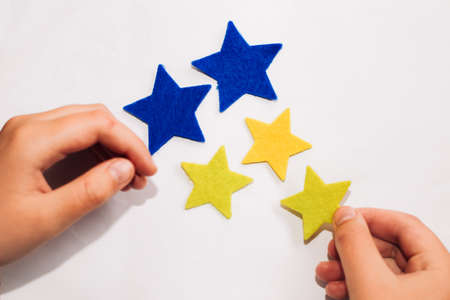 Application of felt stickers of stars in the colors of the blue-yellow Ukrainian flag.の写真素材