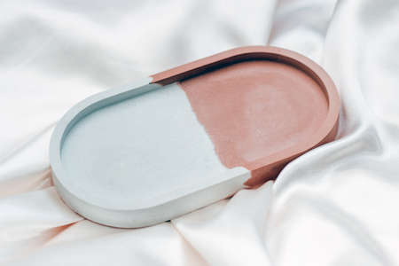 Gypsum marble decorative stand on the background of silk stand.の写真素材