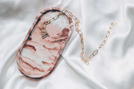 Gypsum marble decorative stand and gold decoration on the background of silk stand.の写真素材