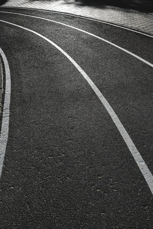 Bicycle treadmill, with white dividing strips, asphalt texture. The concept of the competition.の写真素材