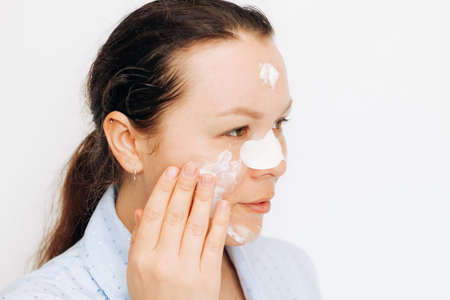 Girl makes a mask for the whole face on problem skin.の写真素材
