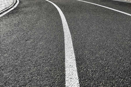 Bicycle treadmill, with white dividing strips, asphalt texture. The concept of the competition.の写真素材