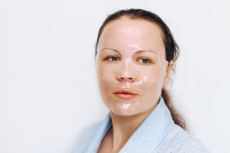 The girl applies a tonal corrective cream on a problematic pigmentation face.の写真素材