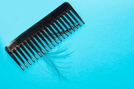Alopecia hair loss concept, fallen hair on combs from disease.の写真素材