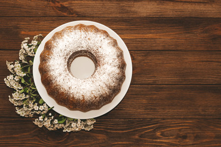 The baked dessert is a round cupcake sprinkled with powder.の写真素材