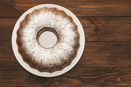 The baked dessert is a round cupcake sprinkled with powder.の写真素材