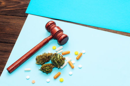 Medical marijuana, inflorescences of shinki herb plant with judge's gavel and pills.の写真素材