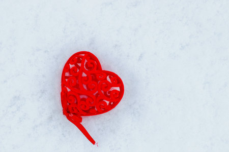 Decorative red heart for valentine's day on snow.の写真素材