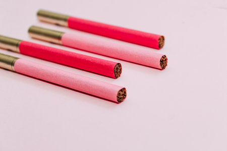 Multicolored cigarettes on a paper background, the concept of a bad habit.の写真素材