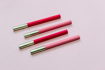 Multicolored cigarettes on a paper background, the concept of a bad habit.の写真素材