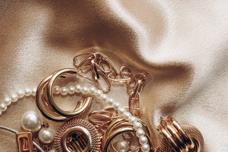 Women's jewelry, gold chain, trendy jewelry on a silk background.の写真素材