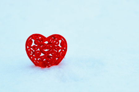 Decorative red heart for valentine's day on snow.の写真素材