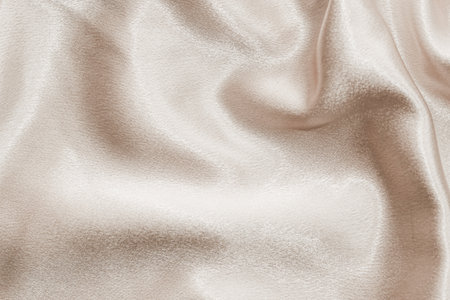 Beige silk fabric texture, Satin fashion Background for content.の写真素材