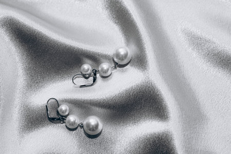 Women's jewelry, gold chain, trendy jewelry on a silk background.の写真素材