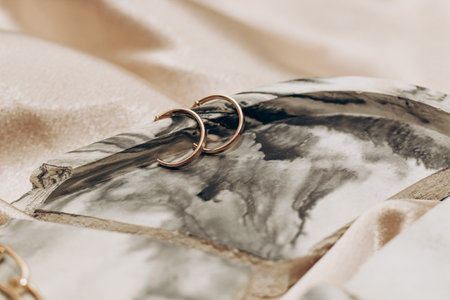 Women's jewelry, gold chain, trendy jewelry on a silk background.の写真素材