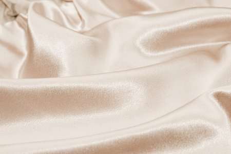 Beige silk fabric texture, Satin fashion Background for content.の写真素材