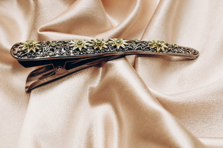 Vintage bronze hair clip with sapphires on a silk background.の写真素材