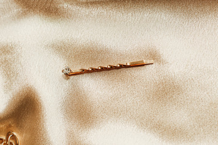 Women's jewelry, gold chain, trendy jewelry on a silk background.の写真素材