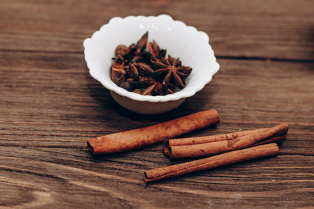 Spices anise, pepper, cumin, cumin, ginger in bowls on a wooden table.の写真素材