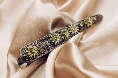 Vintage bronze hair clip with sapphires on a silk background.の写真素材