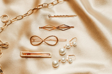 Women's jewelry, gold chain, trendy jewelry on a silk background.の写真素材