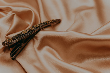Vintage bronze hair clip with sapphires on a silk background.の写真素材
