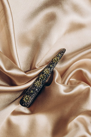 Vintage bronze hair clip with sapphires on a silk background.の写真素材