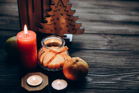 Winter still life with skins, Orange aroma candle in a figured candlestick with a bow.の写真素材