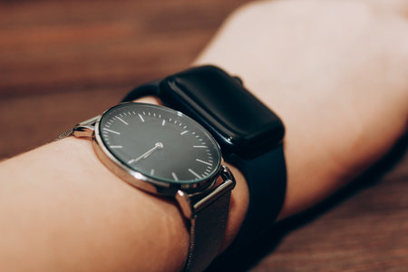 Black technological smart watches and ordinary mechanical watches with a dial.の写真素材