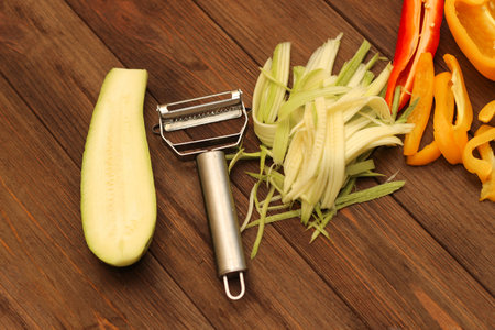 Chopped vegetables, carrots, peppers, zucchini on a vegetable peeler.の写真素材