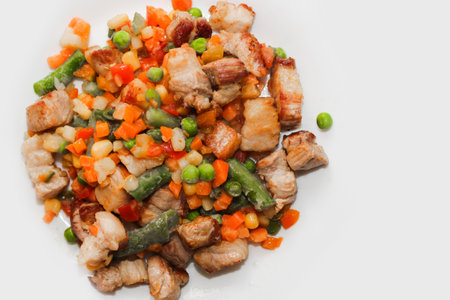 Stewed vegetables with meat, vegetables carrots, peas, beans in a plate.の写真素材