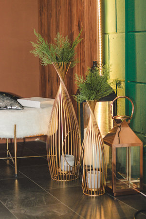 Decorative table with candlesticks and a green composition as a decoration of the interior and decor.の写真素材