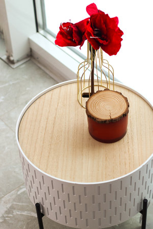Decorative table with a candle and a flower as a decoration of the interior and decor.の写真素材