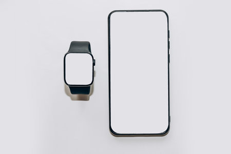 A black technological smart watch has a white screen for a place for text with a phone.の写真素材