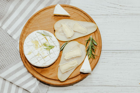 White baguette cut into pieces with olive oil and Camembert cheese on the table.の写真素材