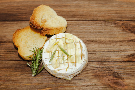 White baguette cut into pieces with olive oil and Camembert cheese on the table.の写真素材