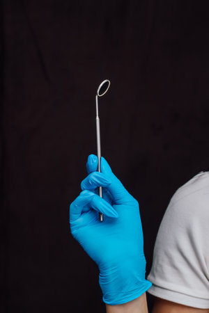 Dental mirror for the oral cavity in the hands of a surgeon.の写真素材