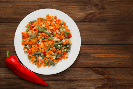Frozen vegetables carrots, peas, beans in a plate.の写真素材